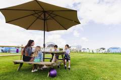 Family-on-bench-by-campsite-Gallery-About-Us-Atlantic-Reach