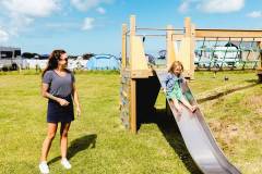 Family-in-outdoor-playground-area-contemporary-cottages-Atlantic-Reach