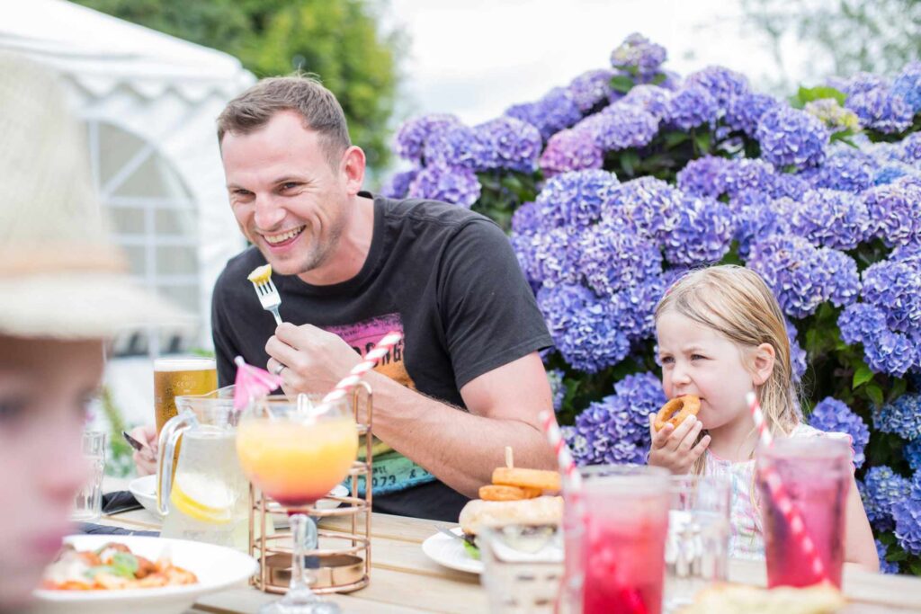 Family enjoying a meal together in a self-catering cottage at Atlantic Reach