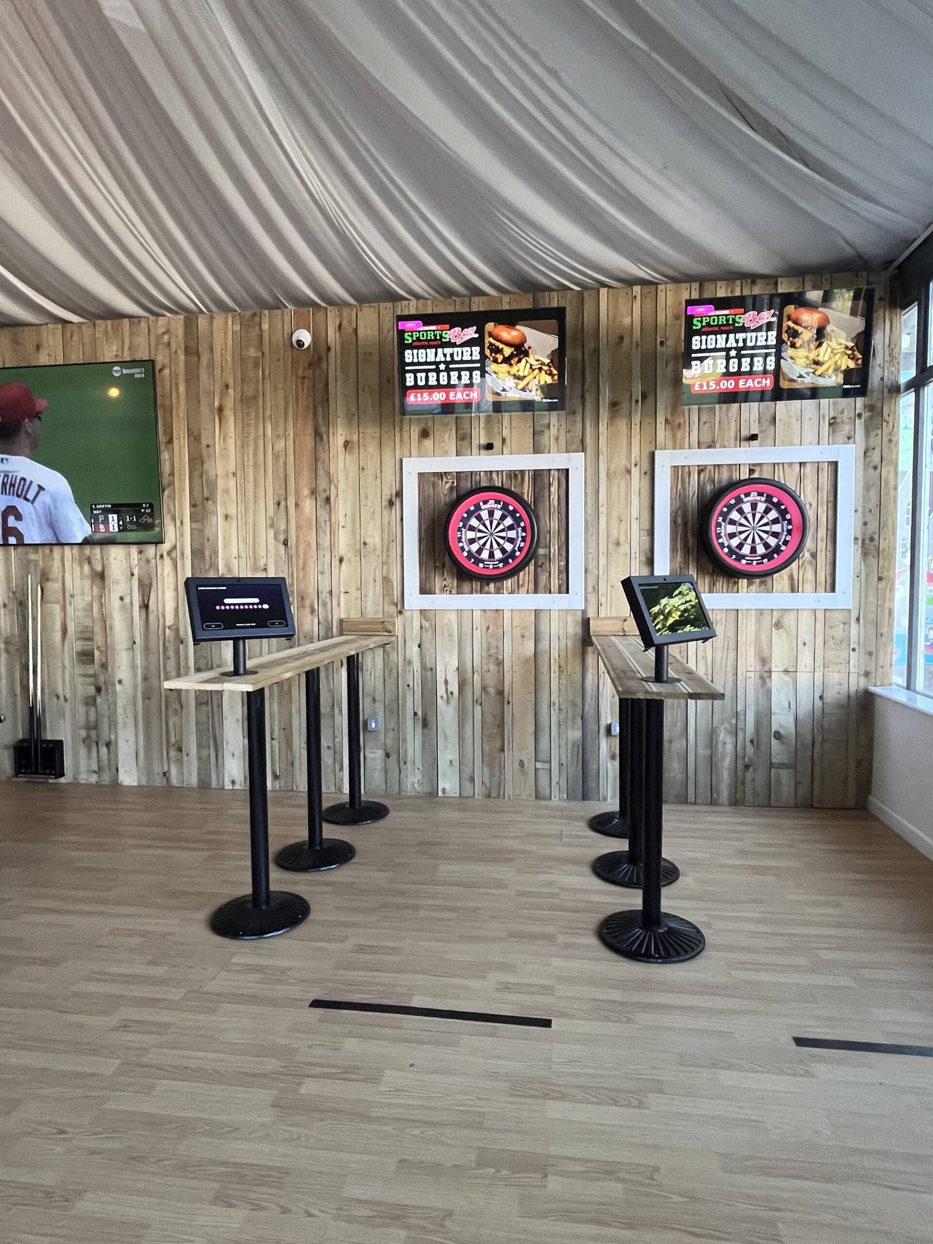 Interactive darts boards and touchscreen scoring stations at The Manor Sports Bar, Atlantic Reach
